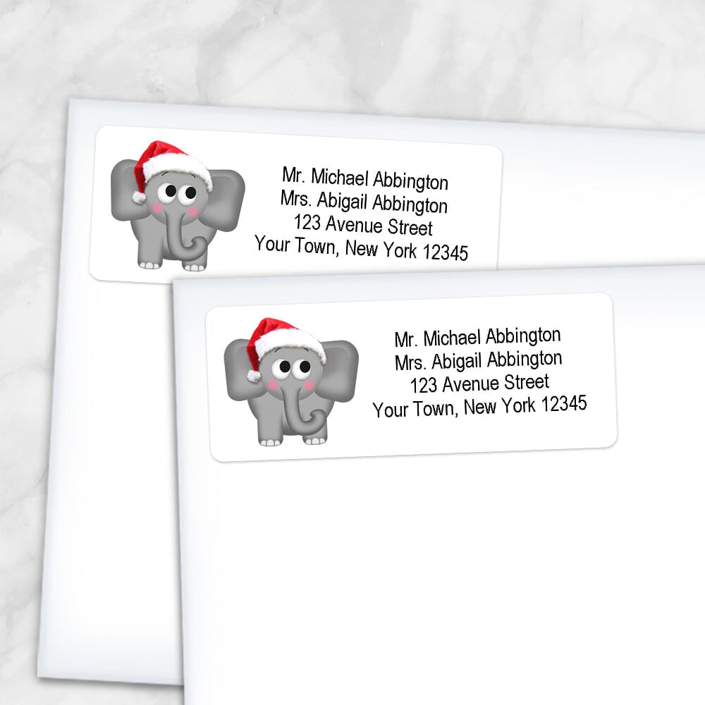 Printable Cute Santa Hat Elephant Address Labels at Printable Planning. Shown on envelopes.
