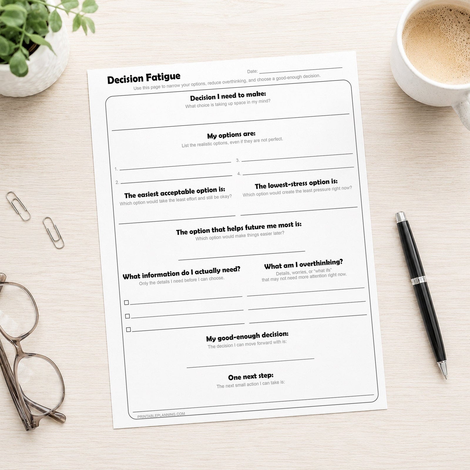 Decision Fatigue Printable Worksheet on a desk with a pen, plant, glasses, and coffee.