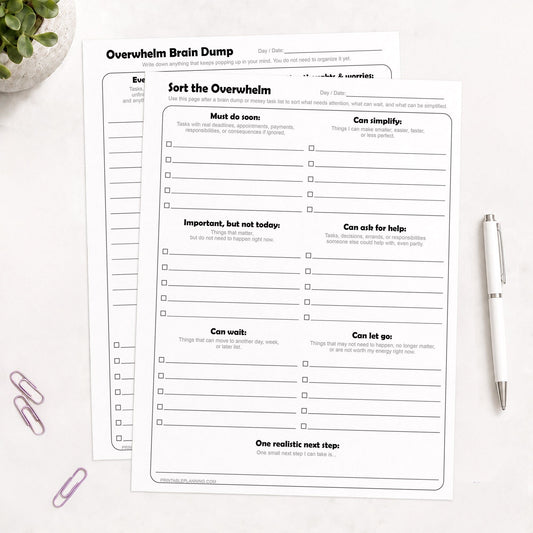 Overwhelm Brain Dump and Task Organizer Printable Worksheets (Bundle) shown on a light desk with a pen, paperclips, and a plant.