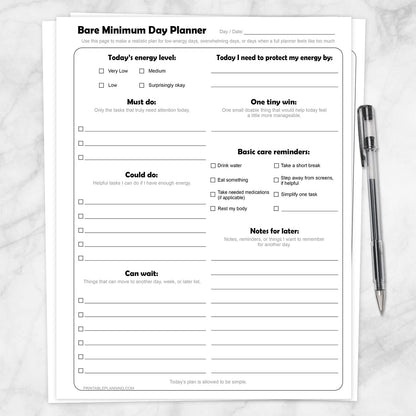 Bare Minimum Day Planner Printable shown on a marble surface with a pen.