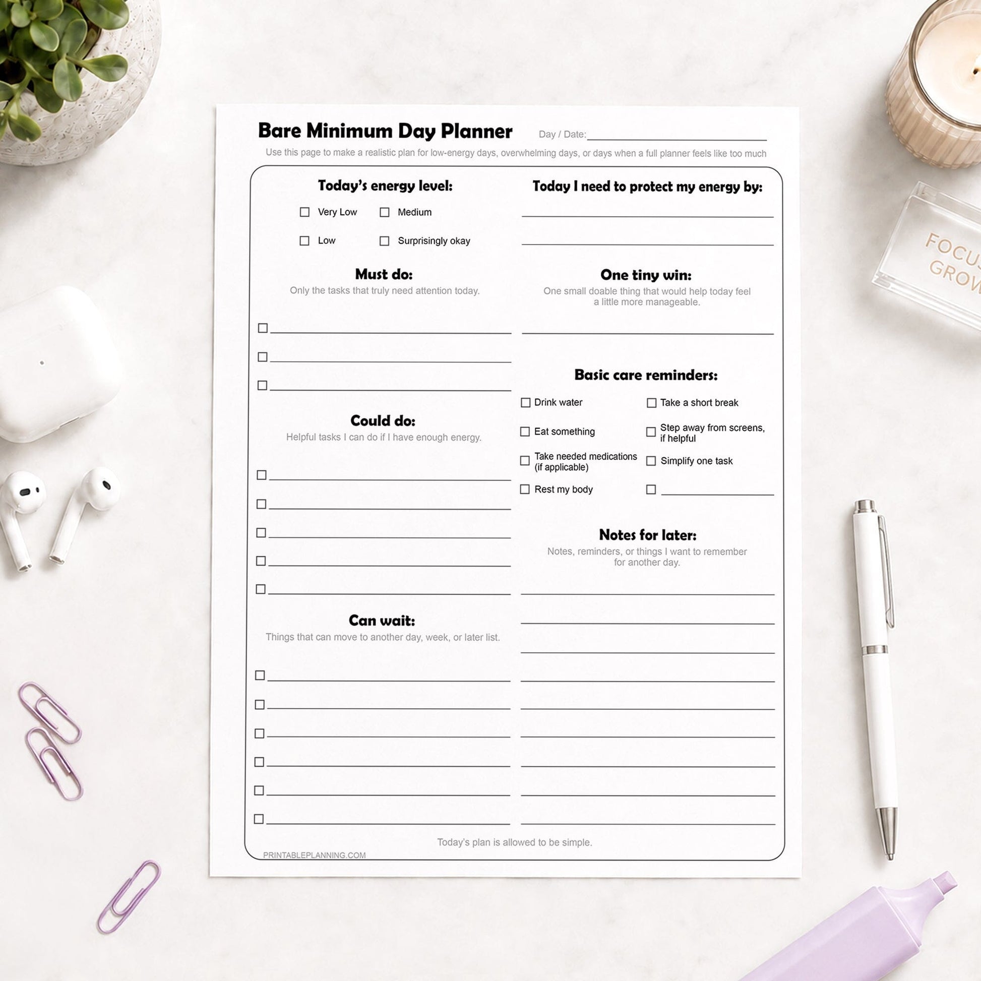 Bare Minimum Day Planner - Printable Page shown on a light desk with earbuds, paperclips, a plant, candle, highlighter, and a pen.