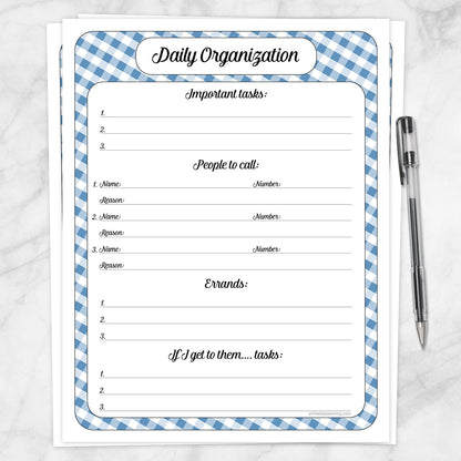 The printable blue gingham Daily Planner with Priorities, Calls, Errands & Tasks page shown on a marble surface with a pen.