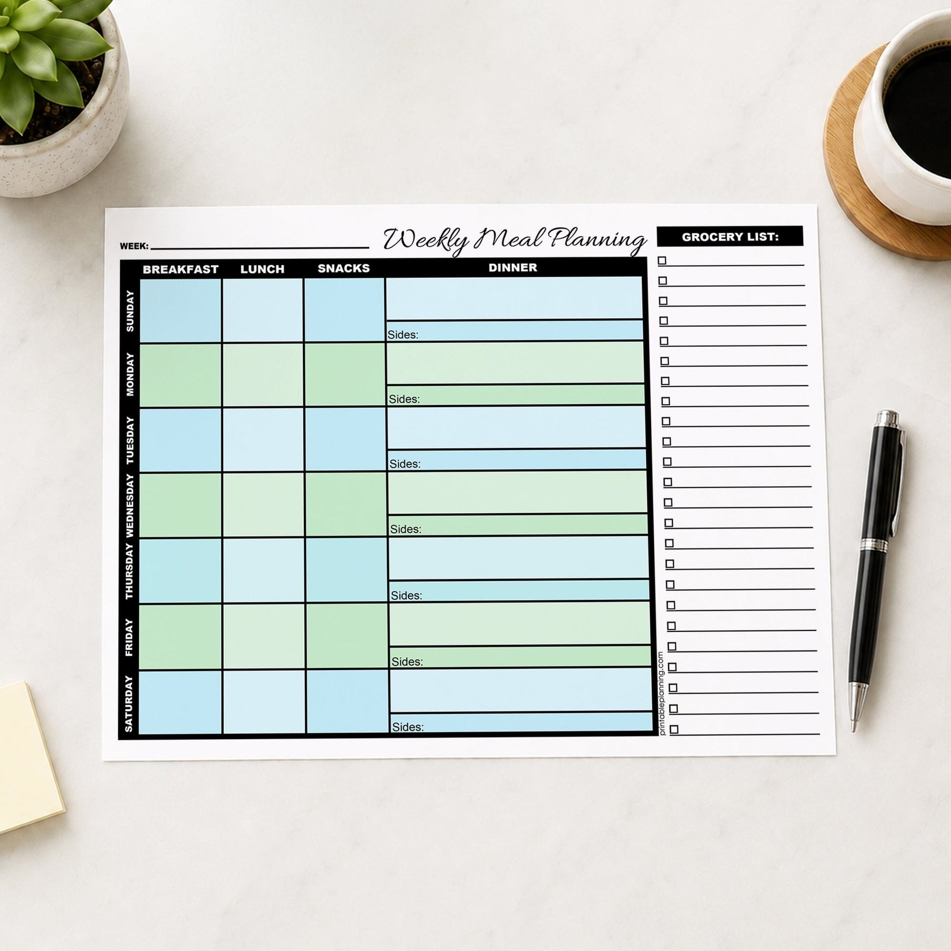A printed Blue Green Weekly Meal Planner with Grocery List (printable page) shown on a table with a plant, notes, coffee, and a pen.
