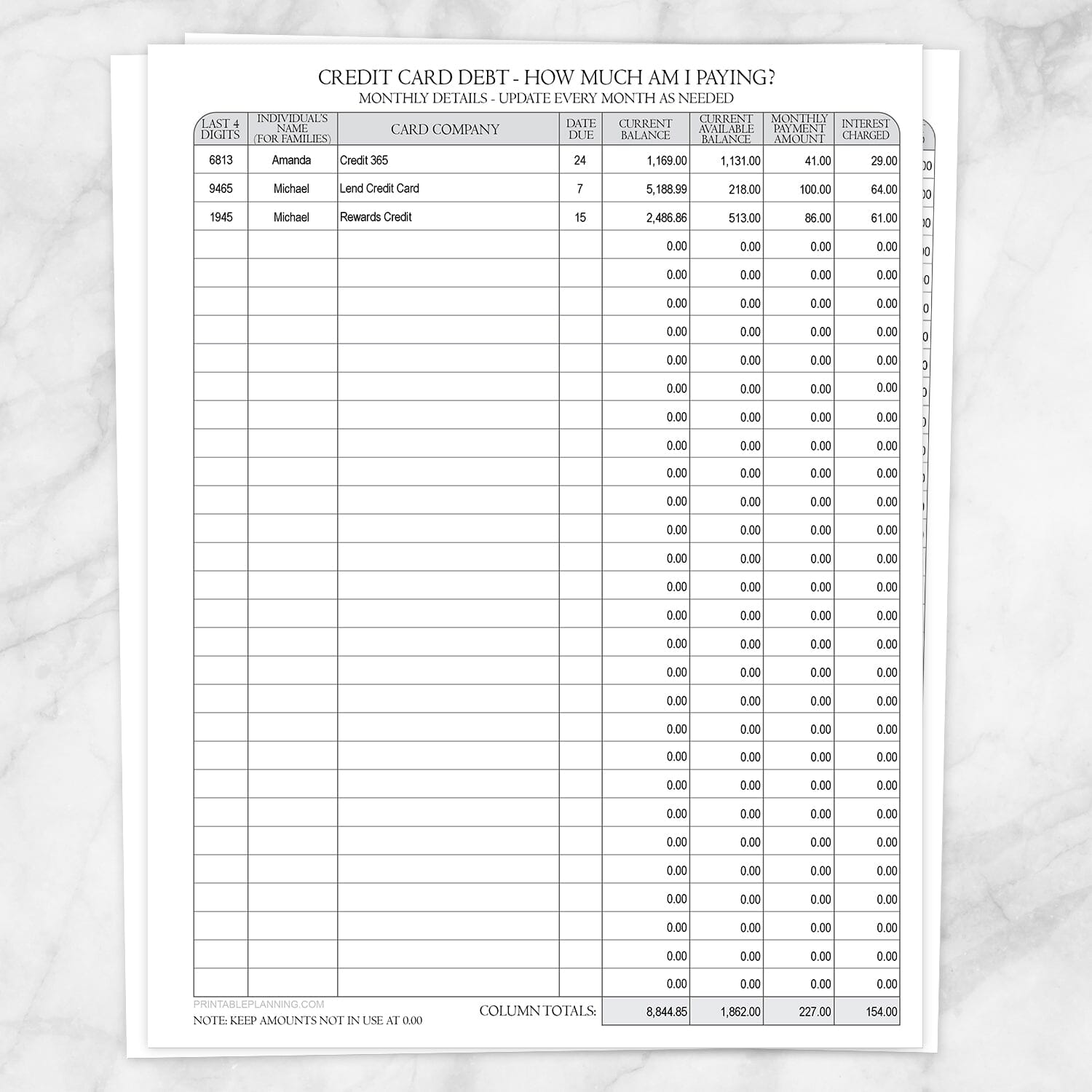 Printable Credit Card Debt Tracker with Auto-Calculating Totals shown on a marble surface.