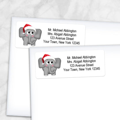 Printable Cute Santa Hat Elephant Address Labels at Printable Planning. Shown on envelopes.