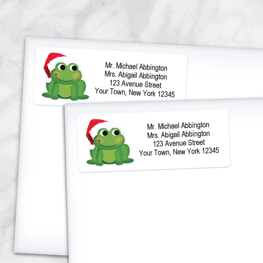 Printable Cute Santa Hat Frog Address Labels at Printable Planning. Shown on envelopes.