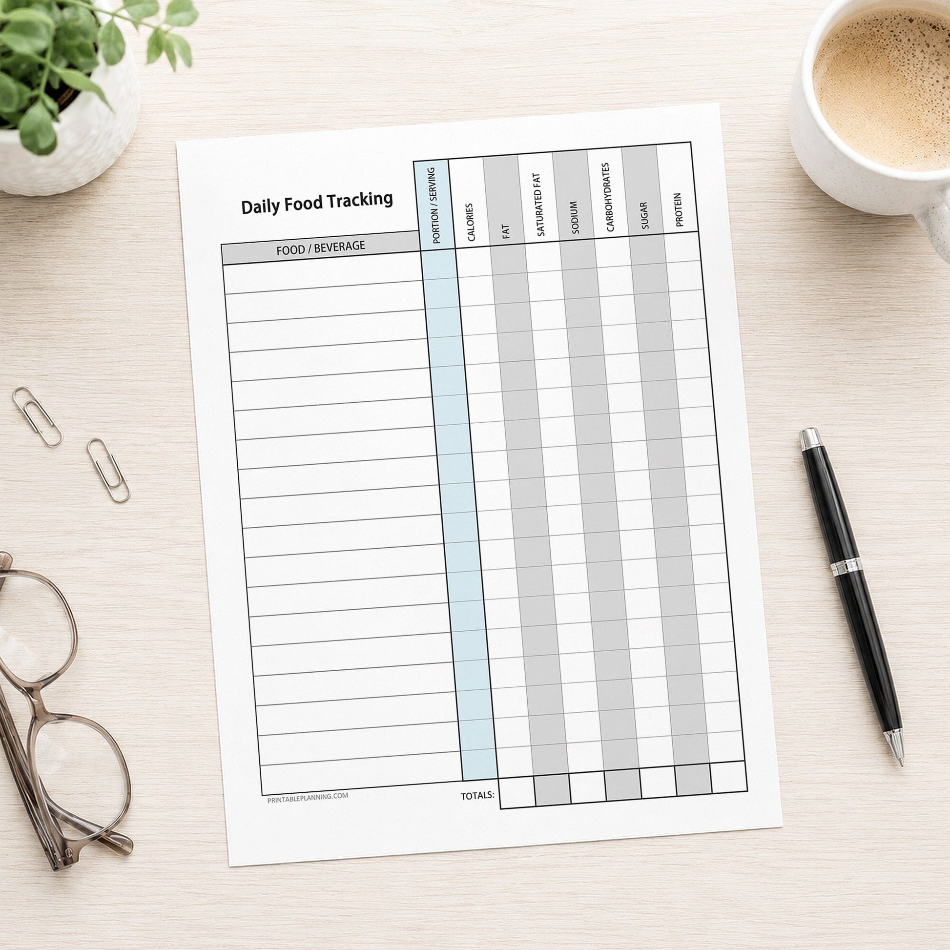 Daily Food Content Tracking Sheet (printable page) shown on a desk with glasses, coffee, a plant, and a pen.