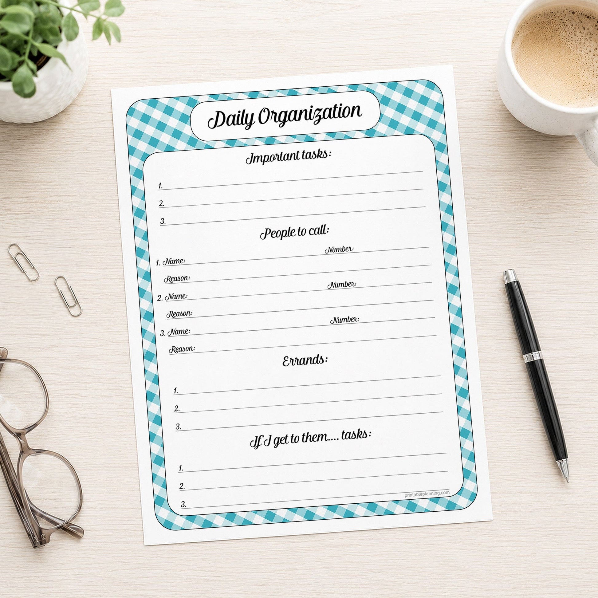 A printed turquoise gingham Daily Planner for Priorities, Calls, Errands & To-Dos (printable) page shown on a desk with a plant, glasses, paperclips, coffee, and a pen.