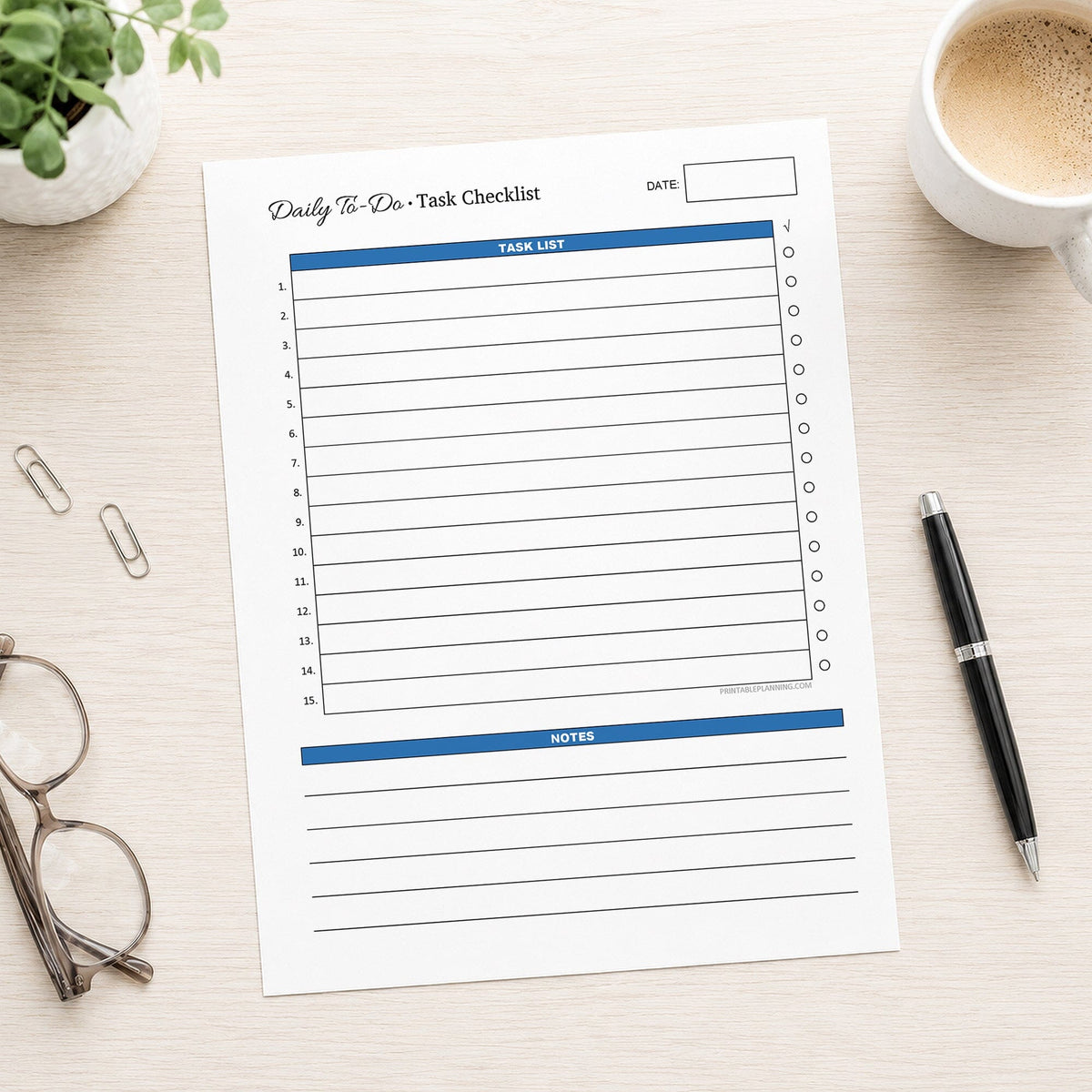 A printed Daily To-Do List & Task Checklist (printable) page, in blue, shown on a desk with a plant, paperclips, glasses, coffee, and a pen.