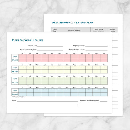 The printable Debt Snowball Tracker & Debt Payoff Plan Bundle pages shown on a marble surface.