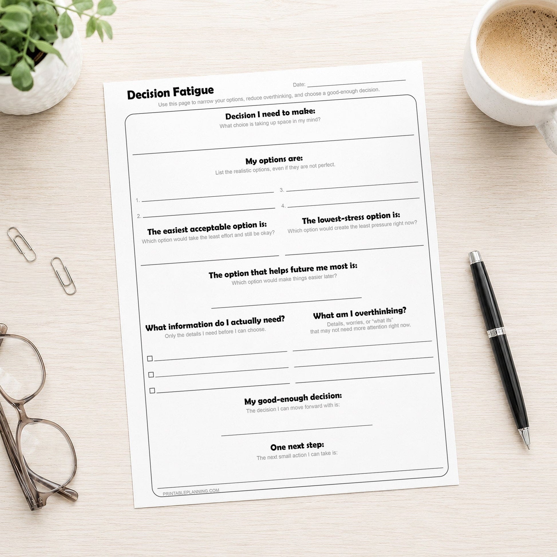 Decision Fatigue Printable Worksheet on a desk with a plant, pen, coffee, and glasses.