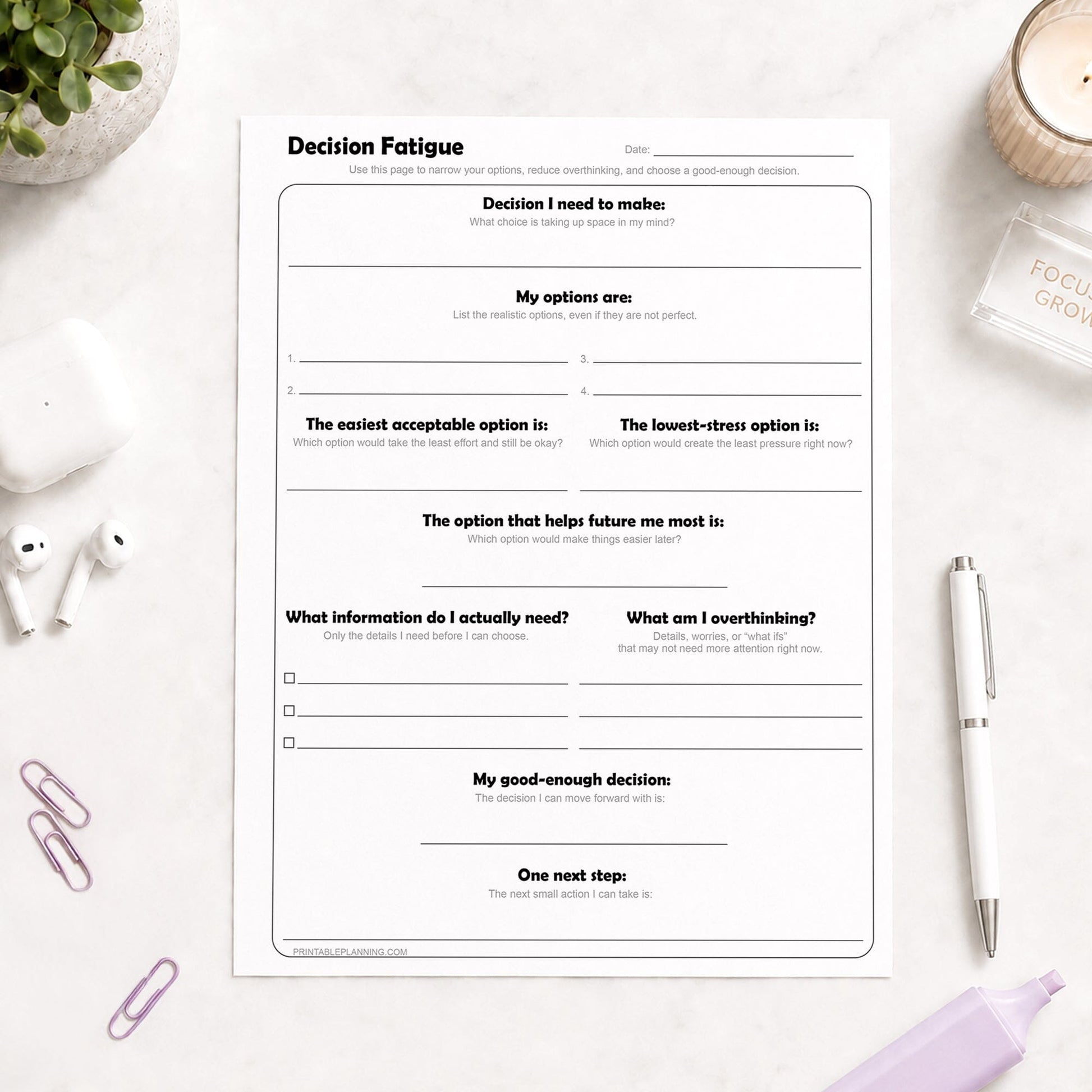 Decision Fatigue Printable Worksheet shown on a light desk with earbuds, candle, pen, highlighter, and plant.