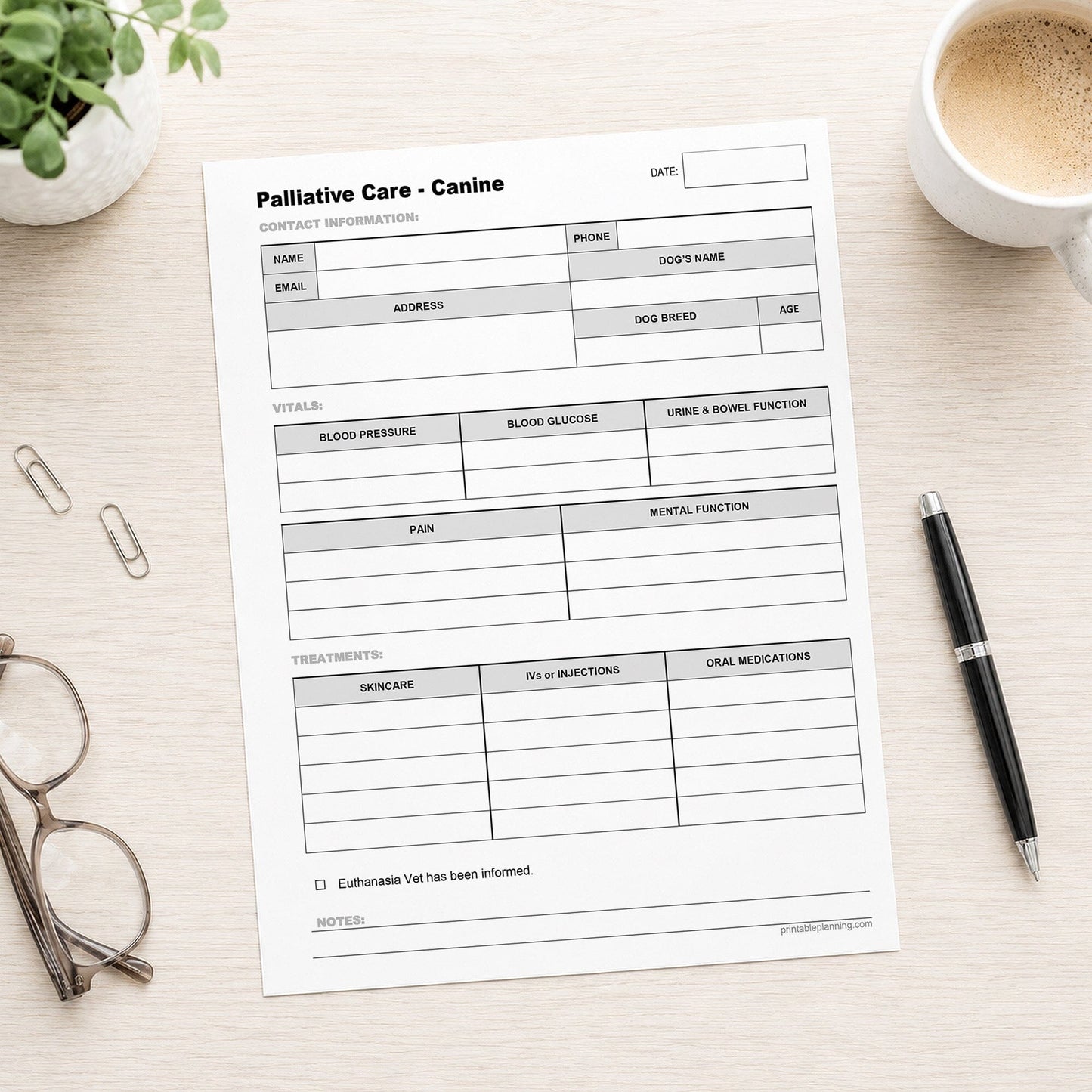A printed Dog Palliative Care Log and Treatment Record (printable page) shown on a desk with a plant, glasses, paperclips, coffee, and a pen.