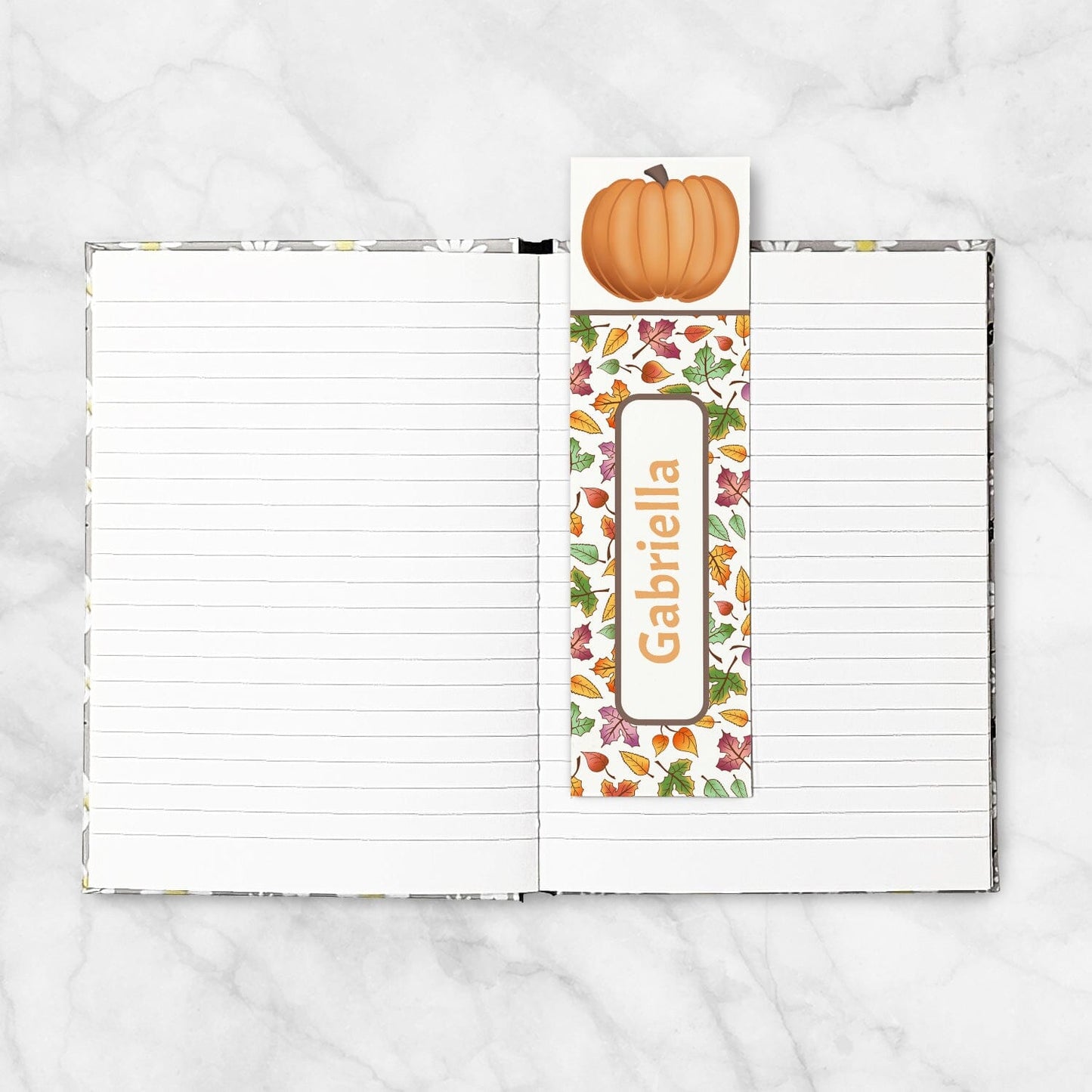 Personalized Pumpkin and Leaves Bookmark shown placed in a blank 5x7 book.