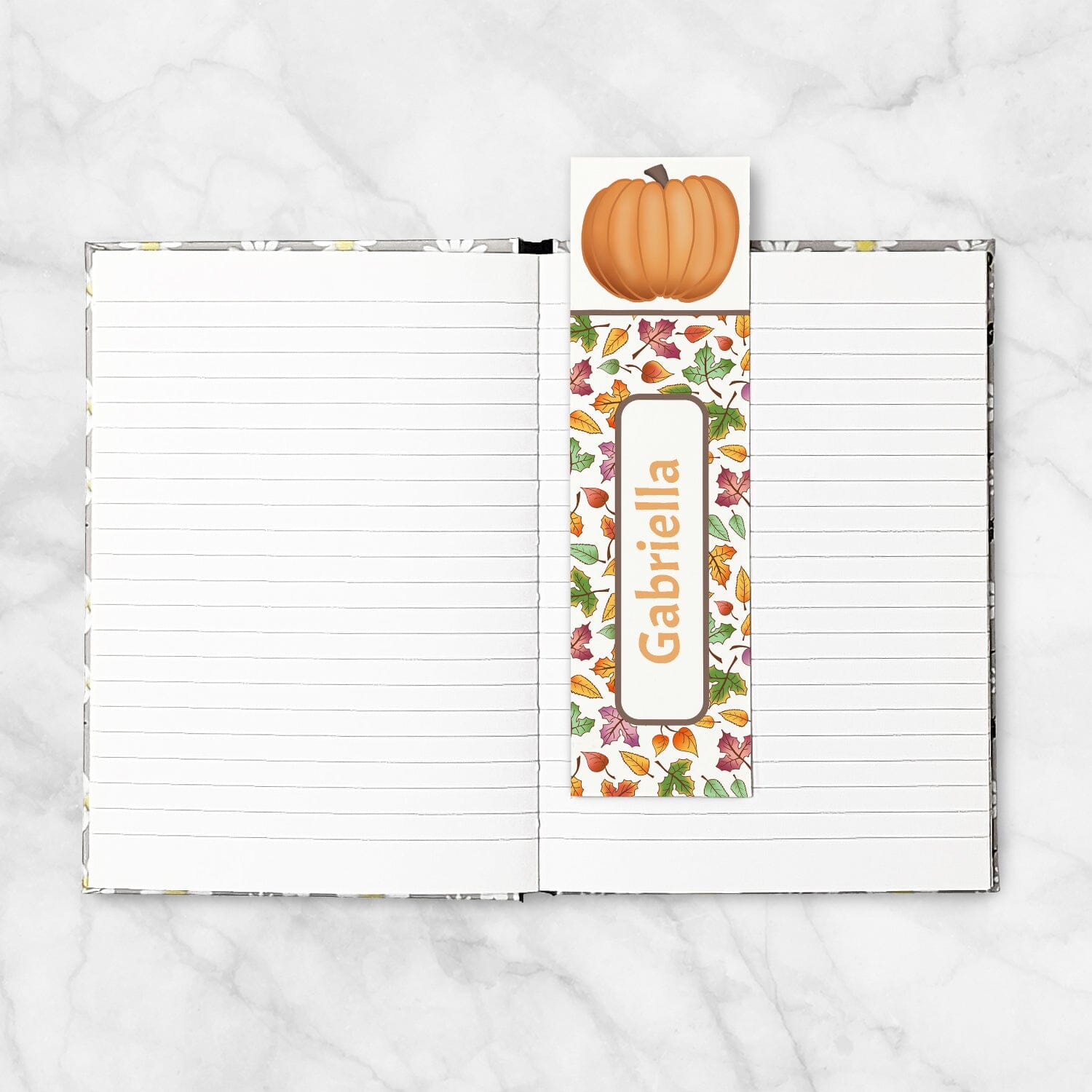 Personalized Pumpkin and Leaves Bookmark shown placed in a blank 5x7 book.