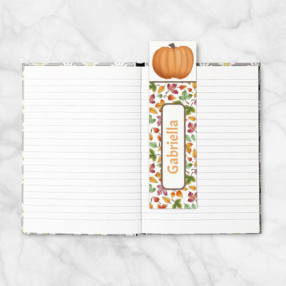 Personalized Pumpkin and Leaves Bookmark shown placed in a blank 5x7 book.