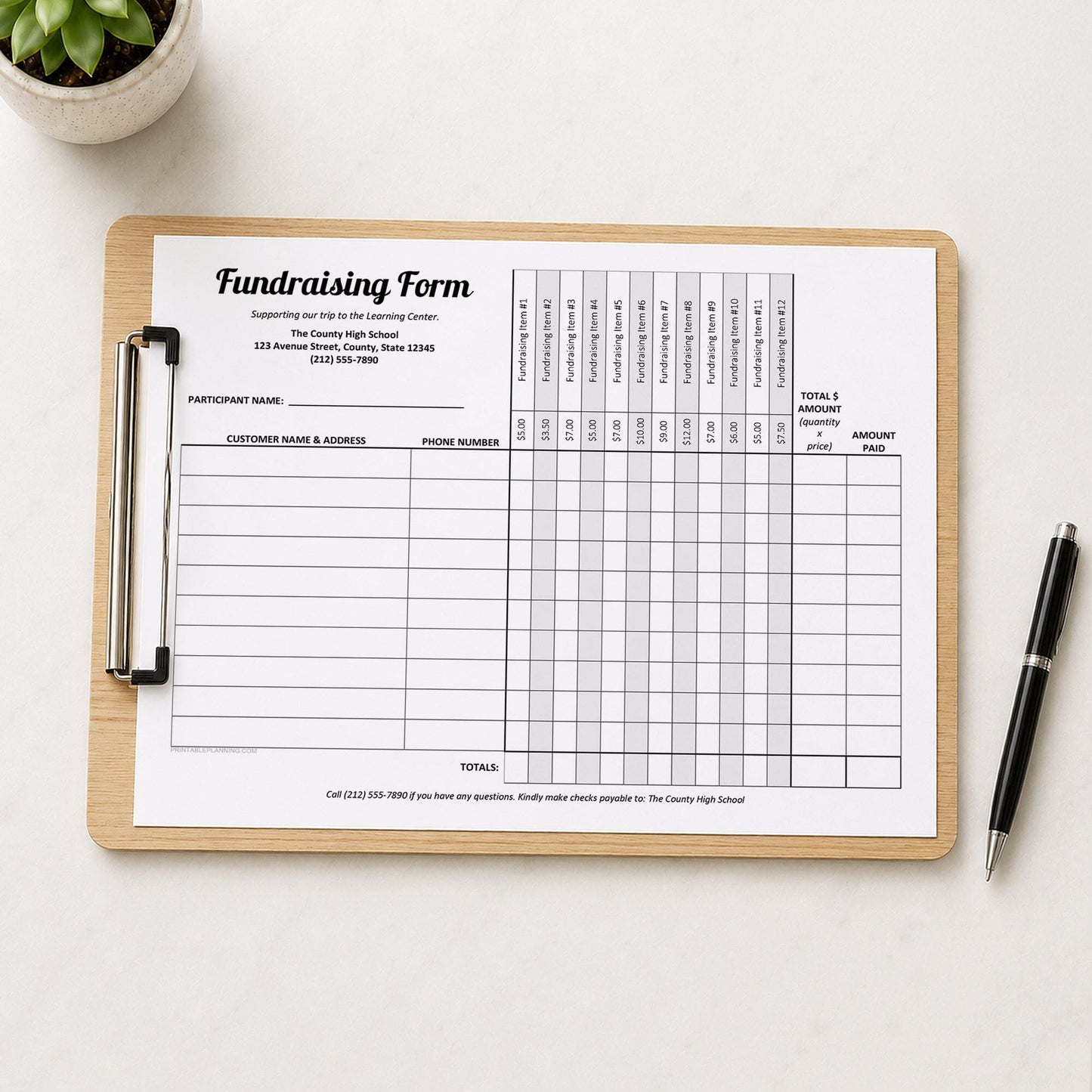 A wooden clipboard holding a printed Fundraiser Order Form with 12 Item Columns, photographed from above on a light neutral surface. A small potted succulent is in the top-left corner and a black pen with a silver clip is in the bottom-right.