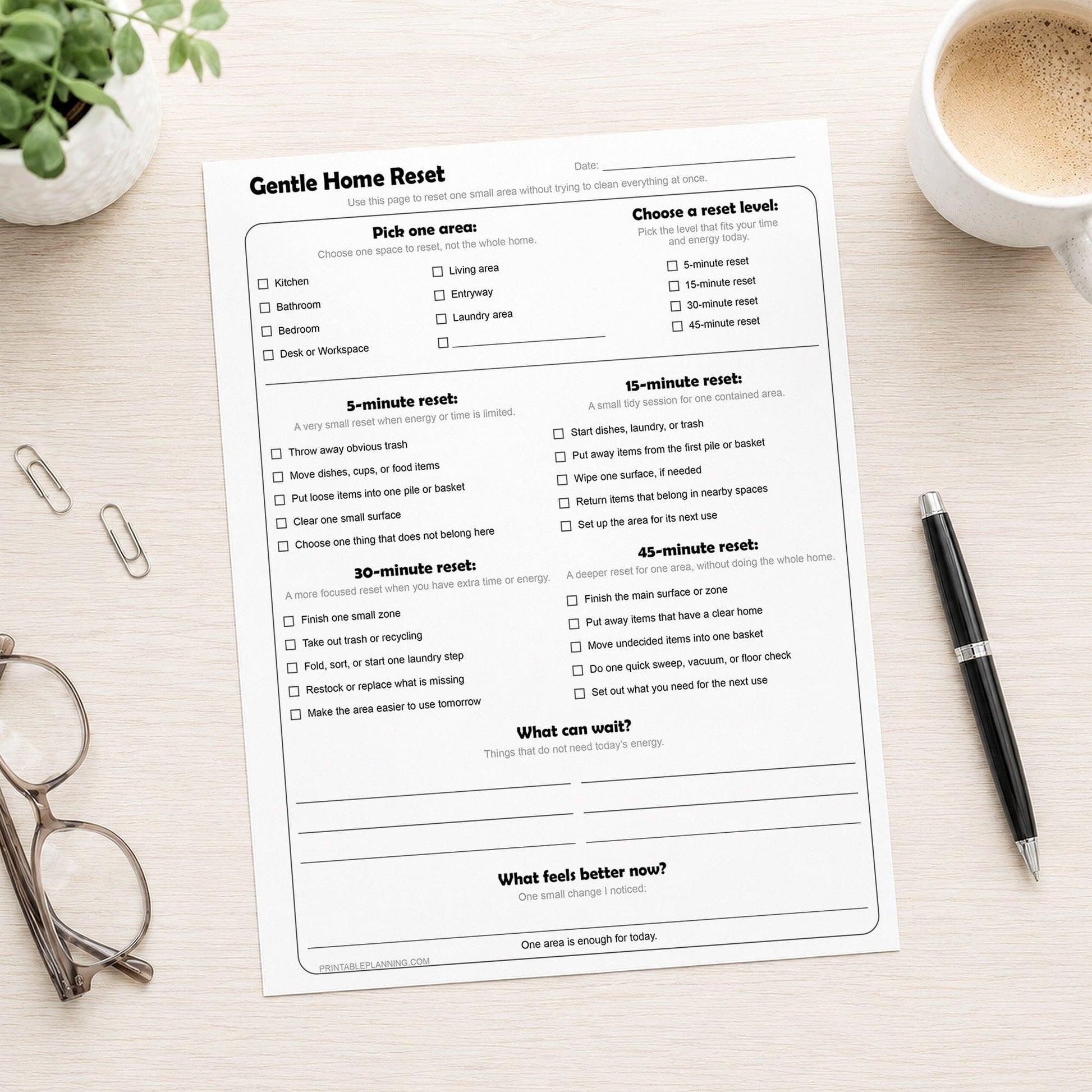 Gentle Home Reset Printable Checklist on a desk with glasses, coffee, plant, and a pen.