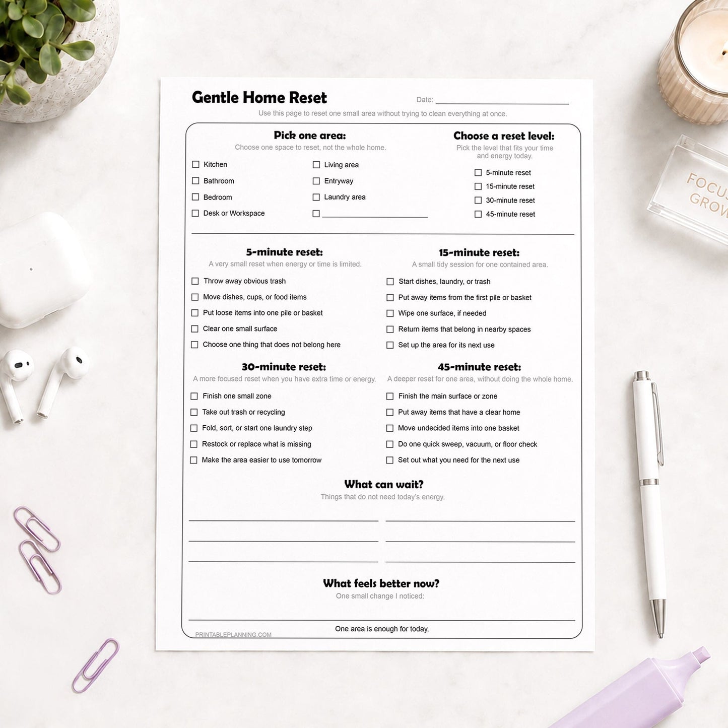 Gentle Home Reset Printable Checklist shown on a light desk with a plant, candle, earbuds, paperclip, highlighter, and a pen.