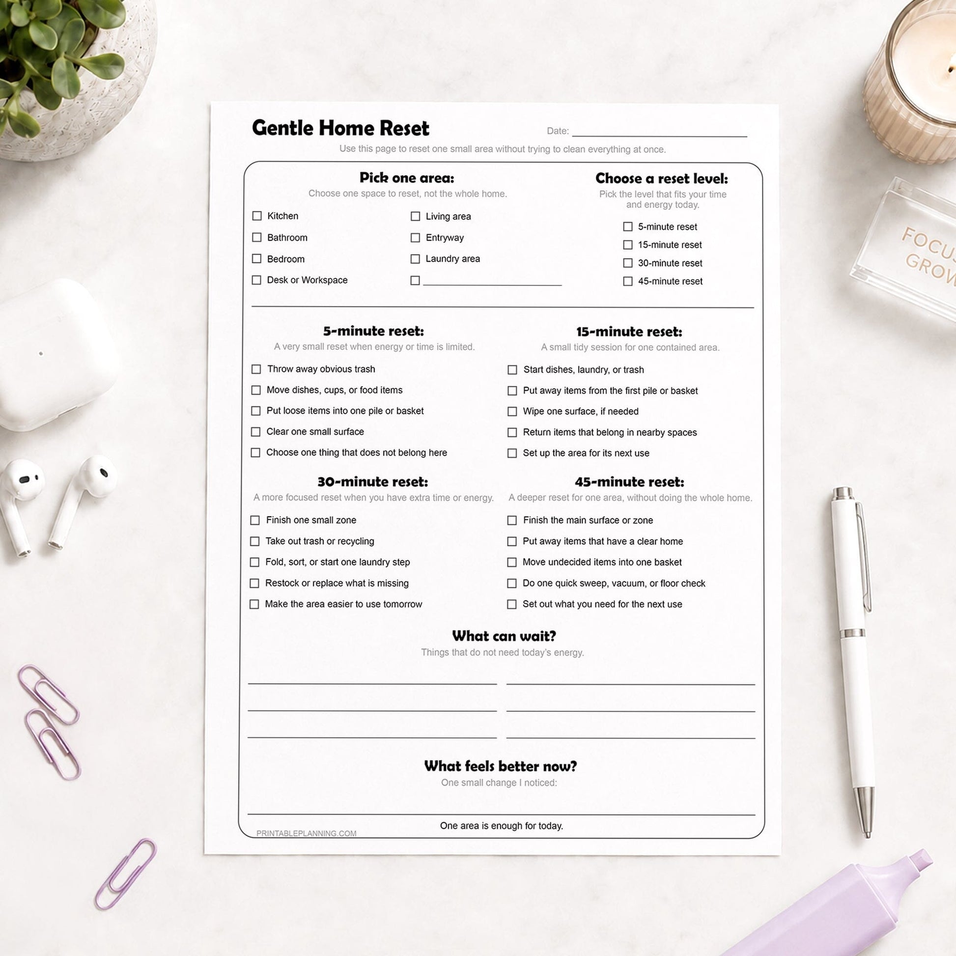 Gentle Home Reset Printable Checklist shown on a light desk with a plant, candle, earbuds, paperclip, highlighter, and a pen.
