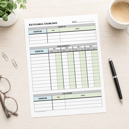 A printed 'Kettlebell Exercises' workout tracker sheet laid on a light wood desk, surrounded by a plant, coffee cup, paper clips, eyeglasses, and a black pen.
