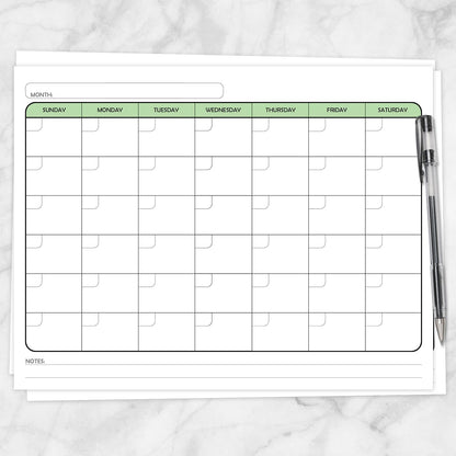 The printable Undated Monthly Calendar - Green Full-Page Planner page shown on a marble surface with a pen.