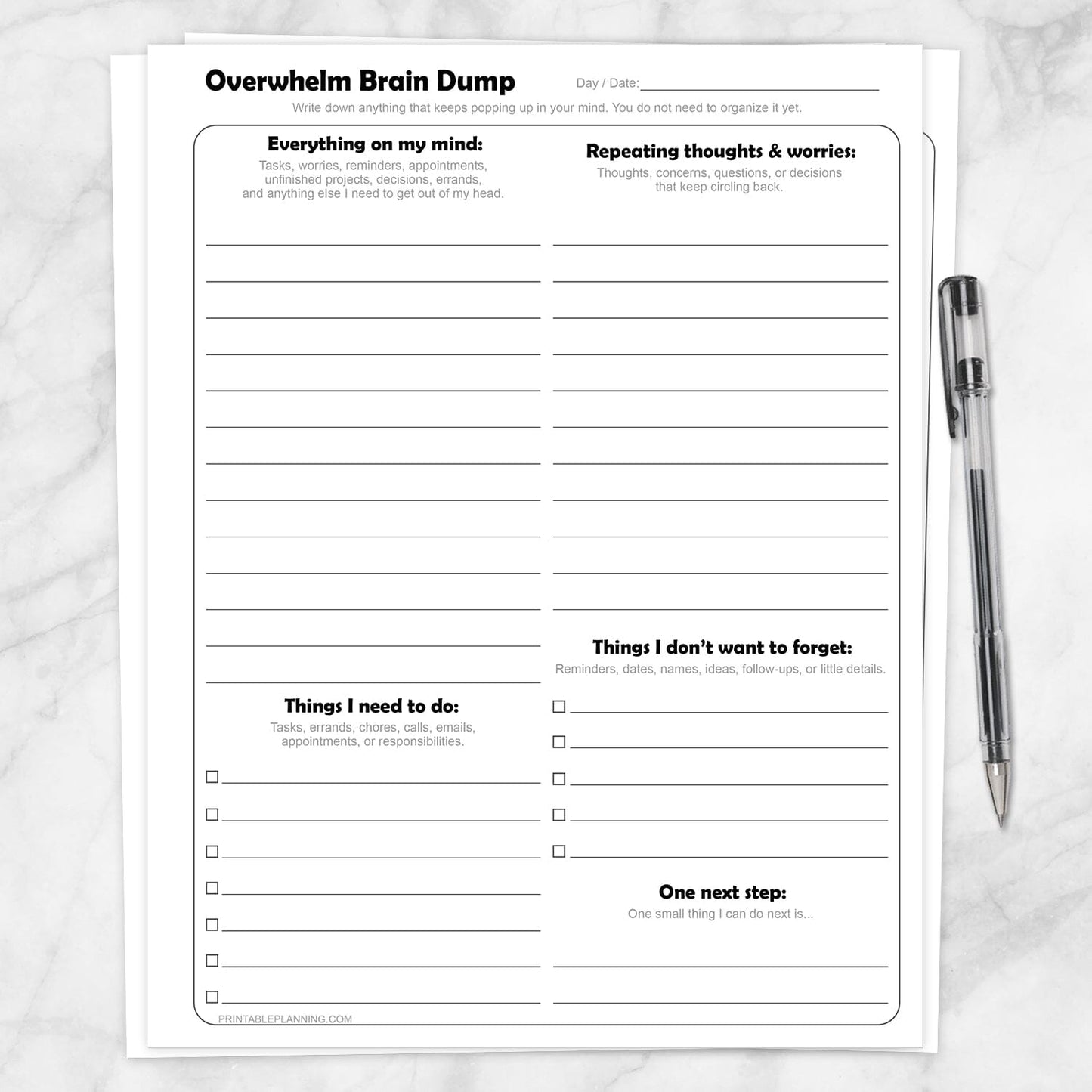 Printable Overwhelm Brain Dump Worksheets shown with a pen on a marble surface.