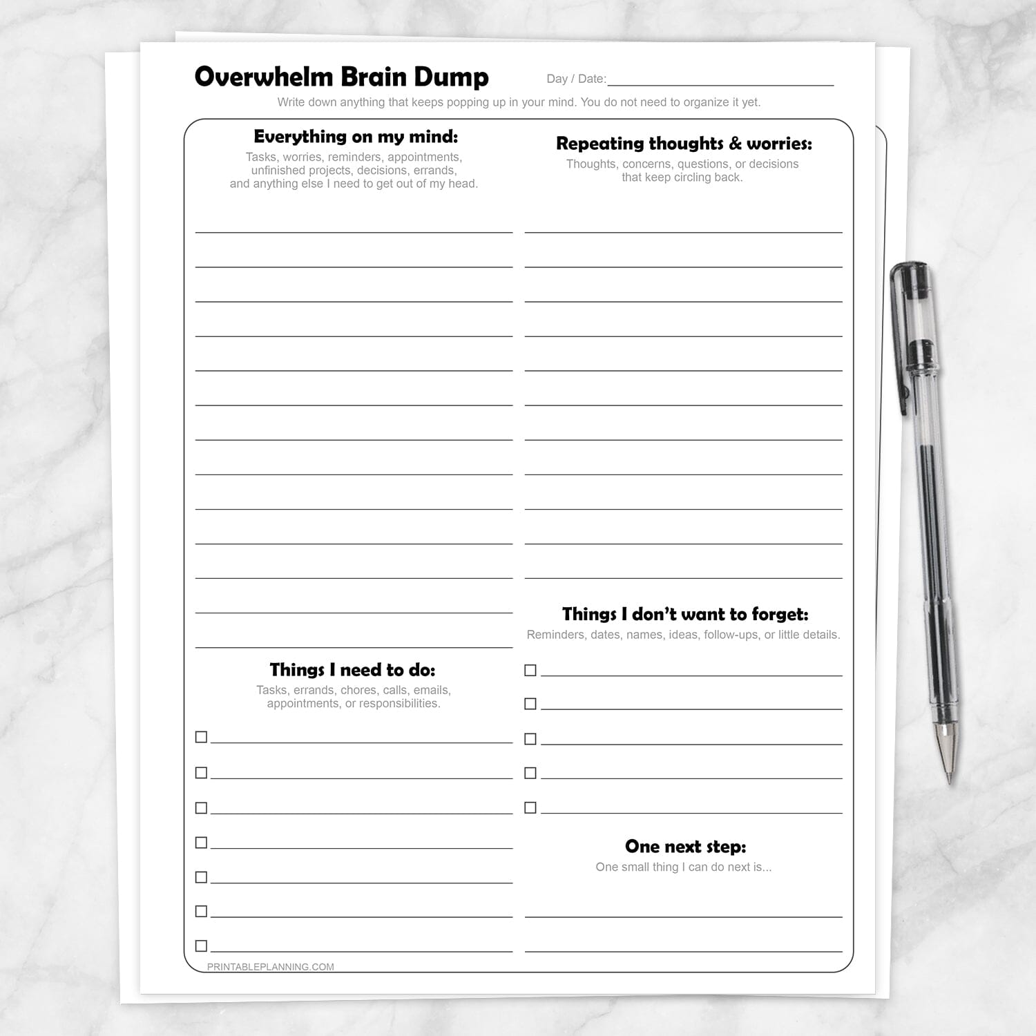 Printable Overwhelm Brain Dump Worksheets shown with a pen on a marble surface.