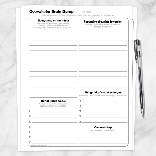 Printable Overwhelm Brain Dump Worksheets shown with a pen on a marble surface.