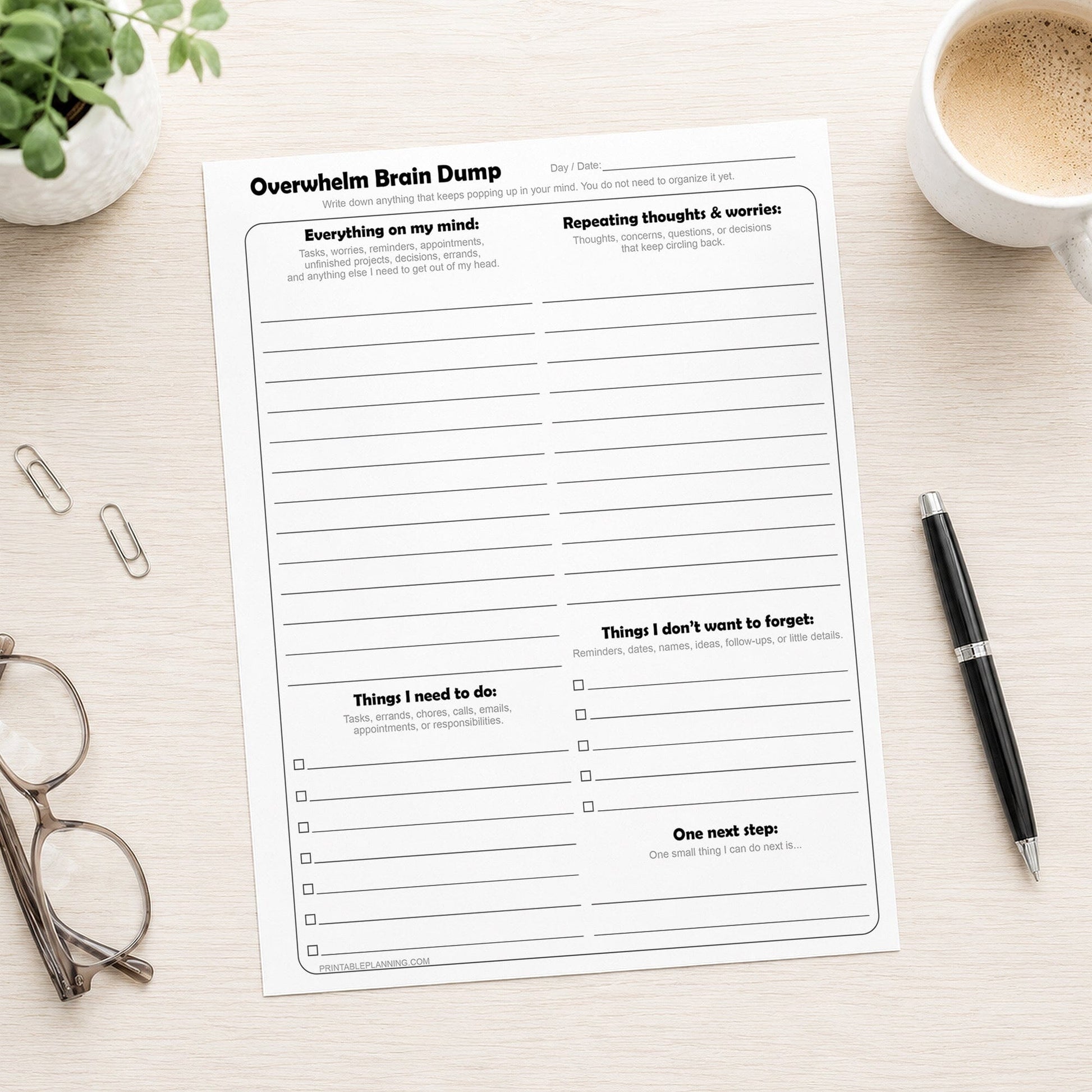 Printable Overwhelm Brain Dump Worksheet shown on a desk with a pen, plant, coffee, and glasses.