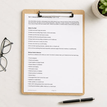 Printed page #31 of the printable Overwhelming Mess Clean-Up Checklist shown on a wooden clipboard on a table with a plant, glasses, and a pen.