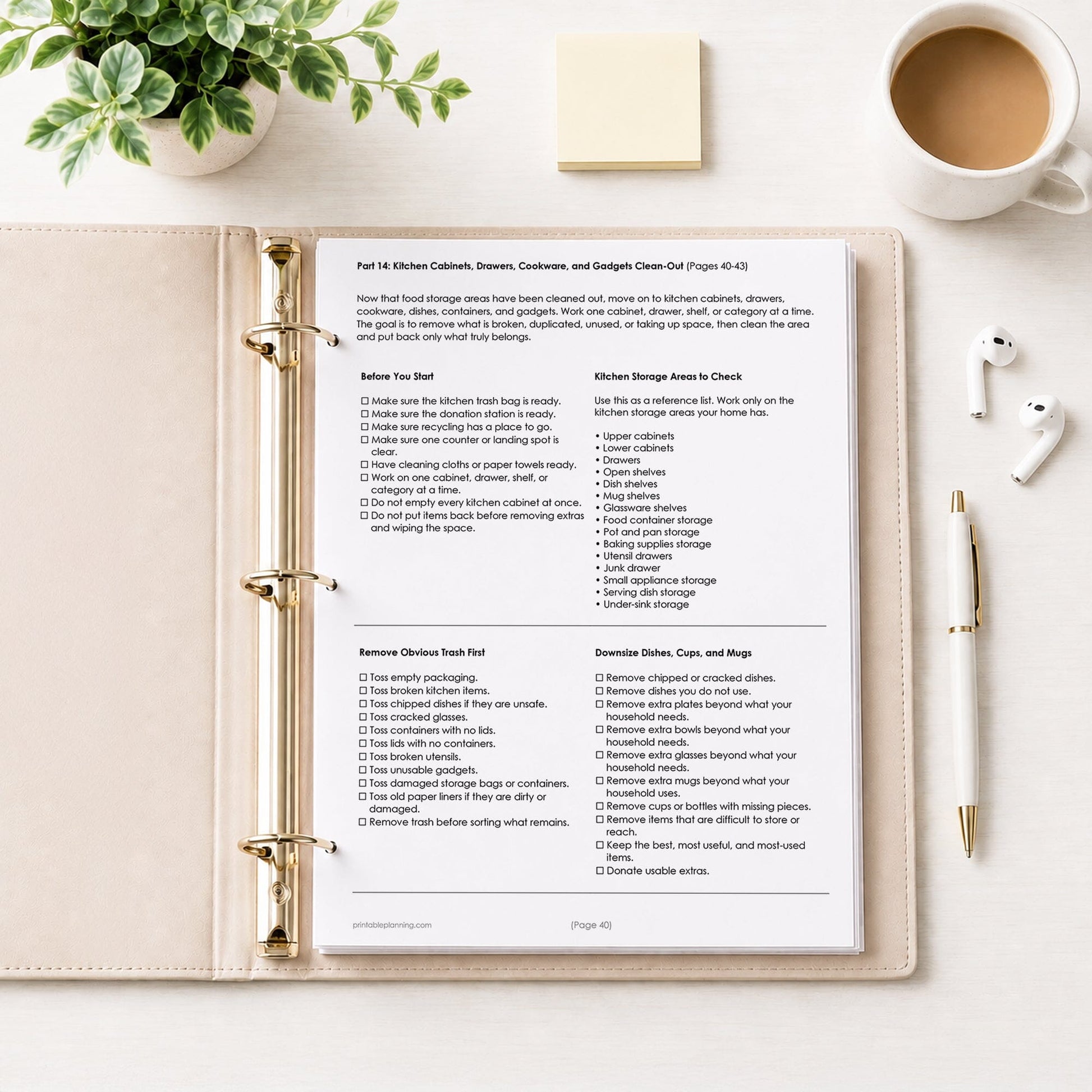 Printed page #40 of the Overwhelming Mess Clean-Up Checklist in a beige binder on a table with a plant, notes, coffee, earbuds, and a pen.