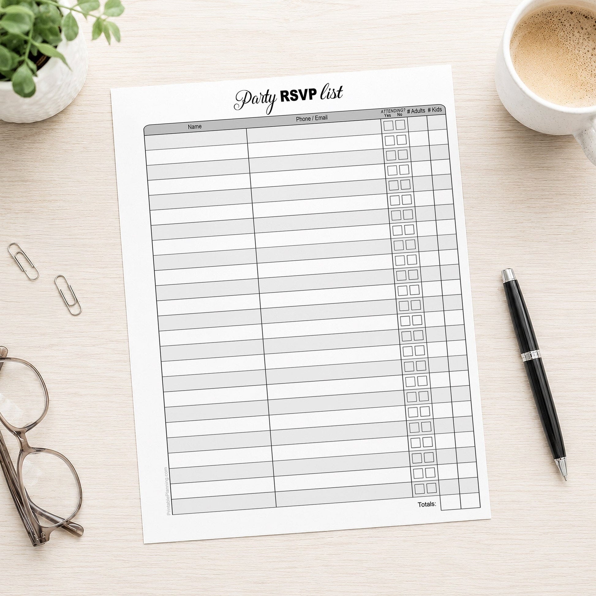 Printable Party RSVP List shown on a desk with glasses, coffee, plant, and a pen.
