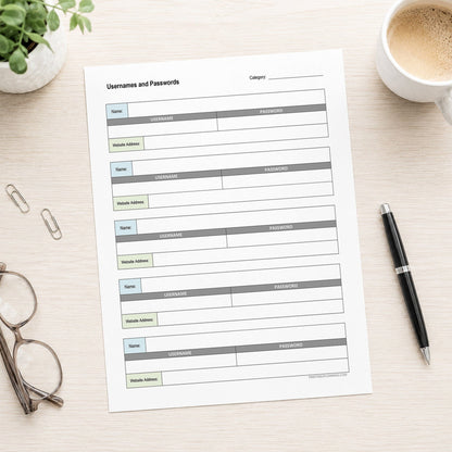 A printed Password Log Sheet for Usernames and Website Logins (printable page) shown on a desk with a plant, paperclips, glasses, coffee, and a pen.