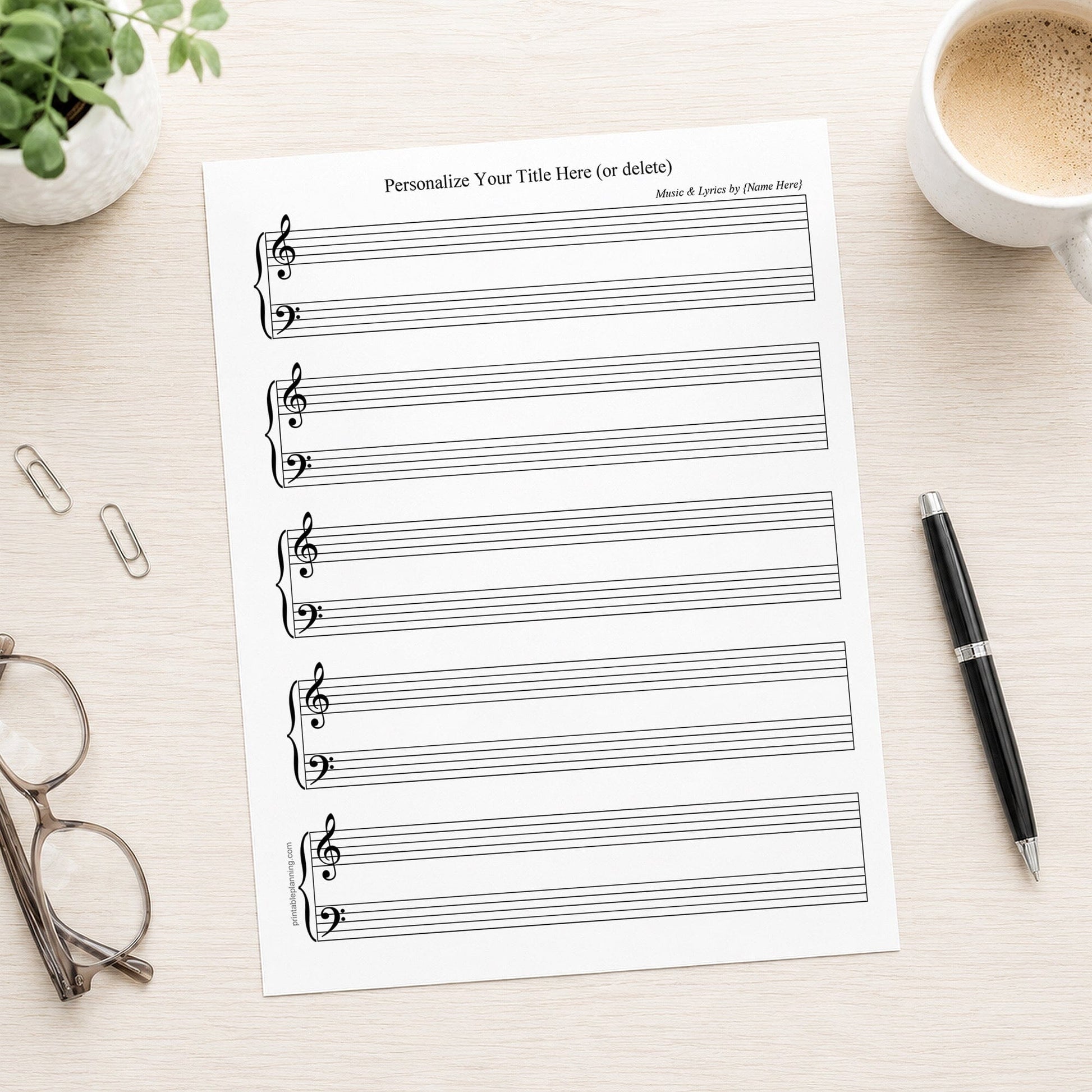 Personalized Blank Piano and Vocals Sheet Music on a desk with lasses, paperclips, coffee, plant, and a pen.