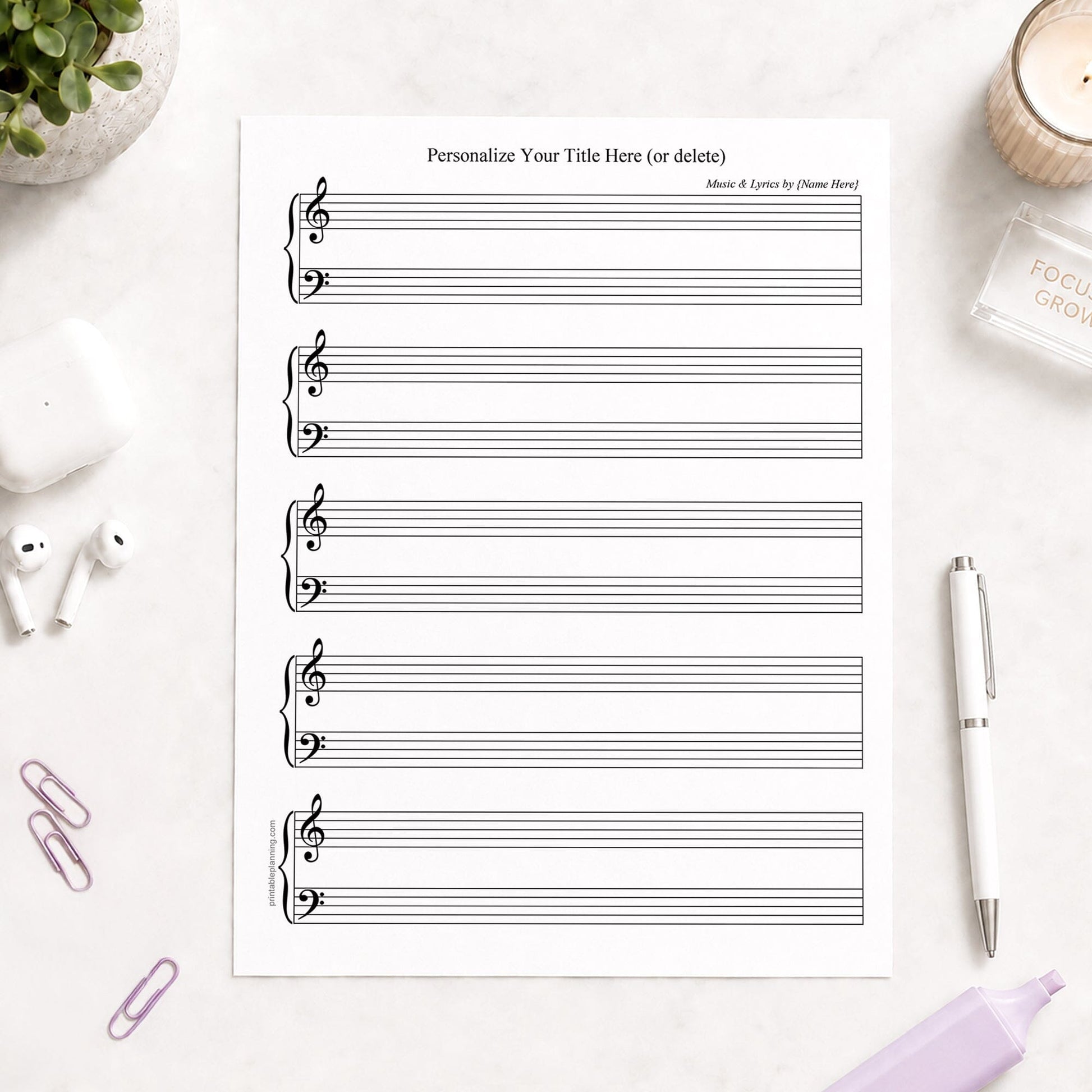 Personalized Blank Piano and Vocals Sheet Music shown on a light desk with earbuds, paperclips, highlighters, plant, and a pen.