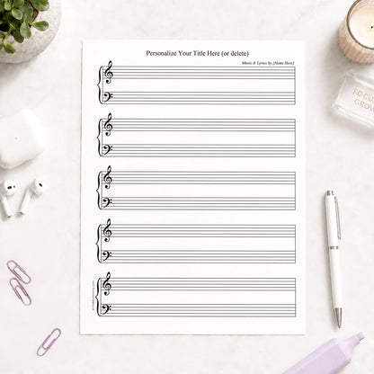Personalized Blank Piano and Vocals Sheet Music shown on a light desk with earbuds, paperclips, highlighters, plant, and a pen.