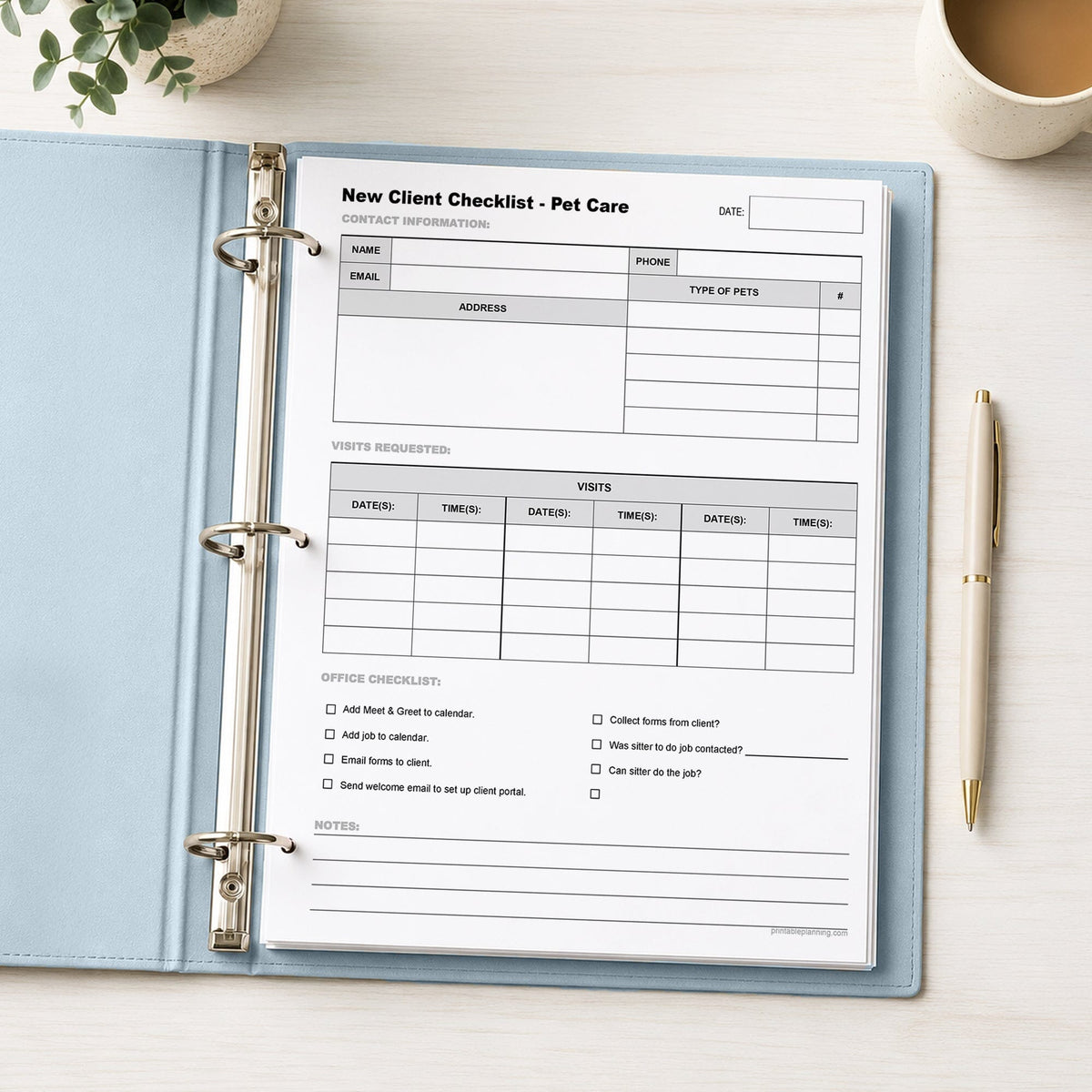 A printed Pet Sitter New Client Checklist with Visit Schedule (printable page) shown in a light blue binder on a desk with a plant, coffee, and a pen.