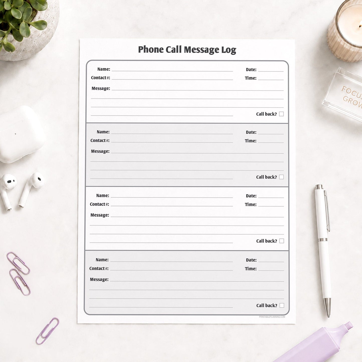 Phone Call Message Log shown on a light desk with earbuds, paperclips, a plant, highlighter, and a pen.
