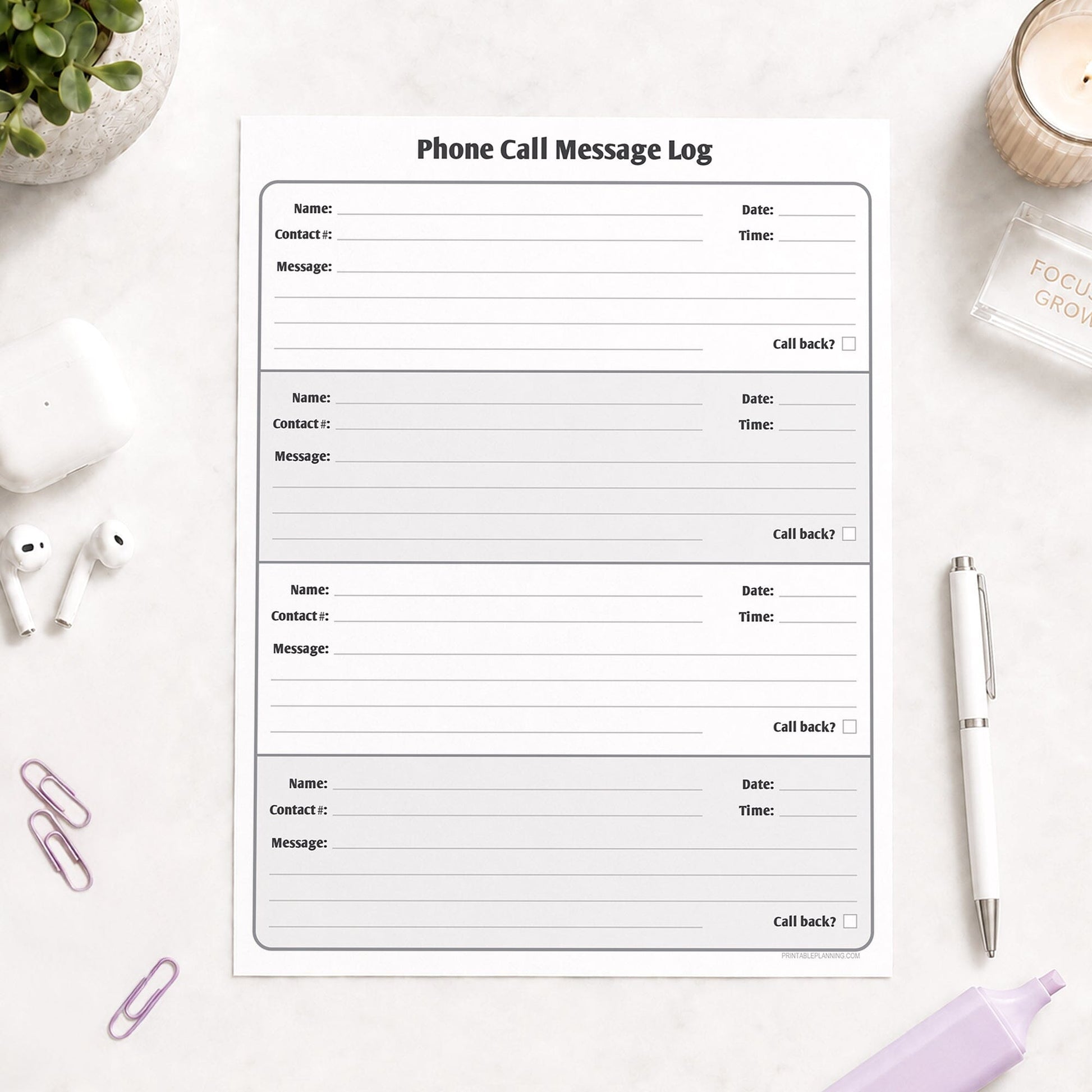 Phone Call Message Log shown on a light desk with earbuds, paperclips, a plant, highlighter, and a pen.