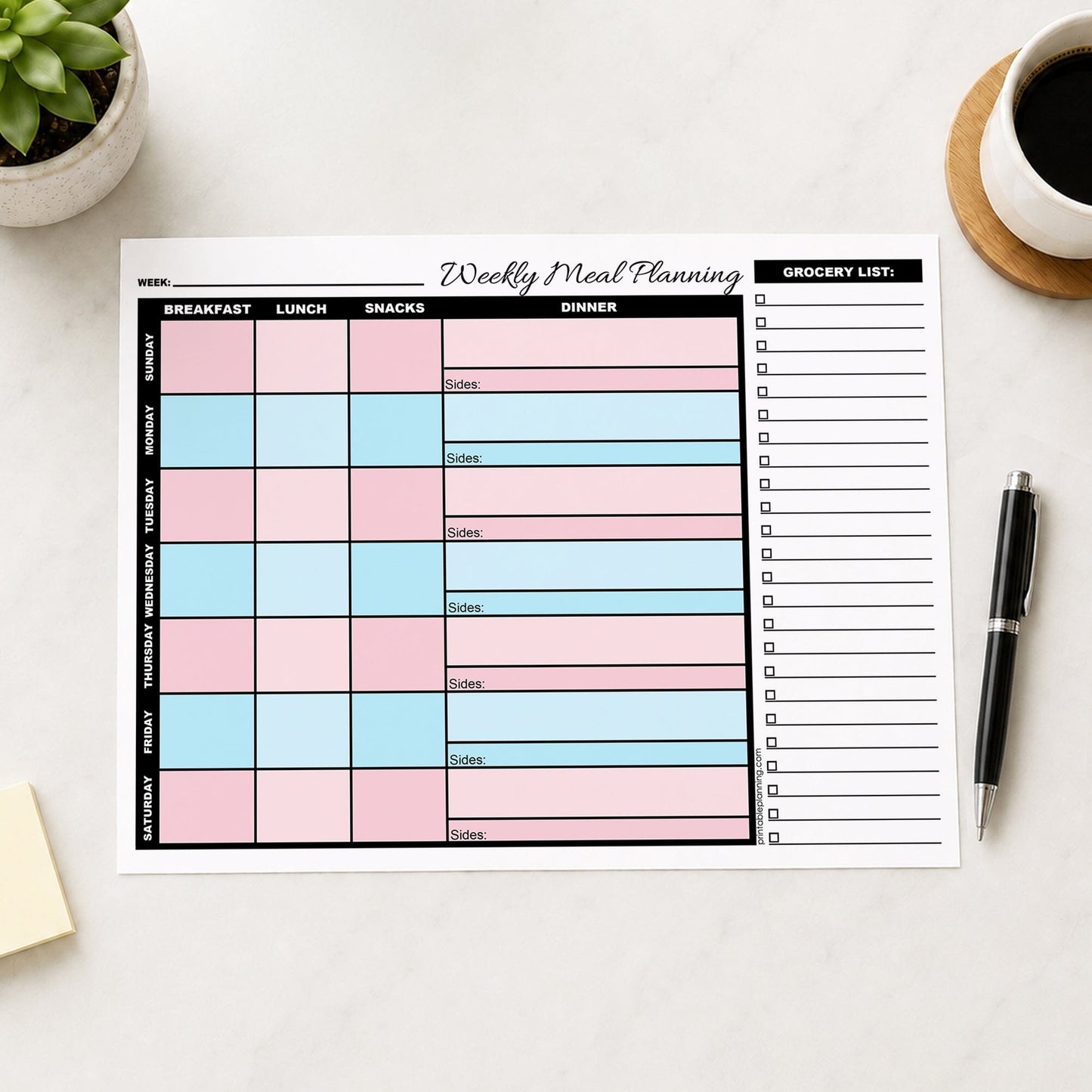 Pink Blue Weekly Meal Planner with Grocery List (printable page) shown on a table with a plant, notes, coffee, and a pen.