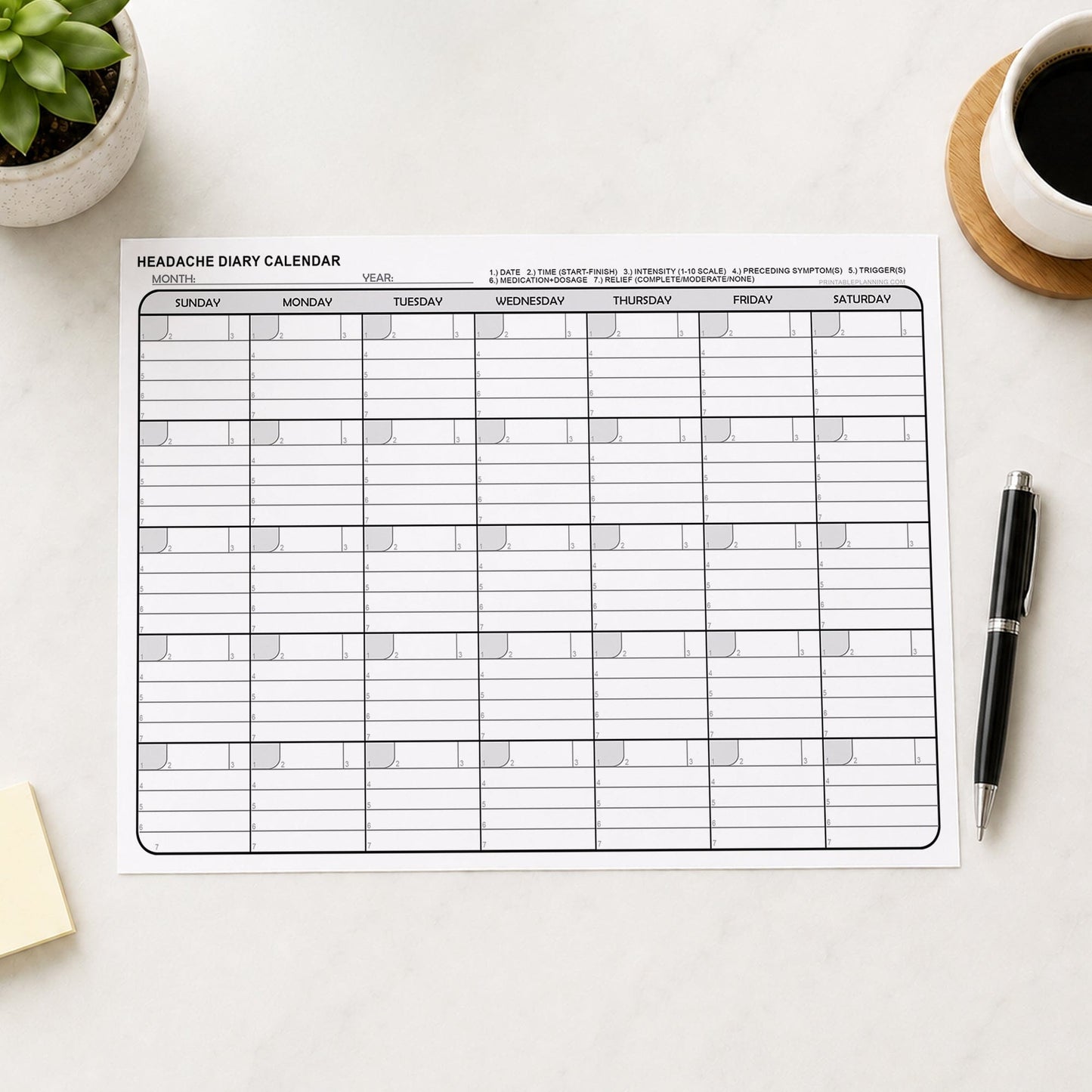 Printable Headache Diary Calendar - Monthly Migraine Tracker PDF shown on a desk with notes, coffee, plant, and a pen.