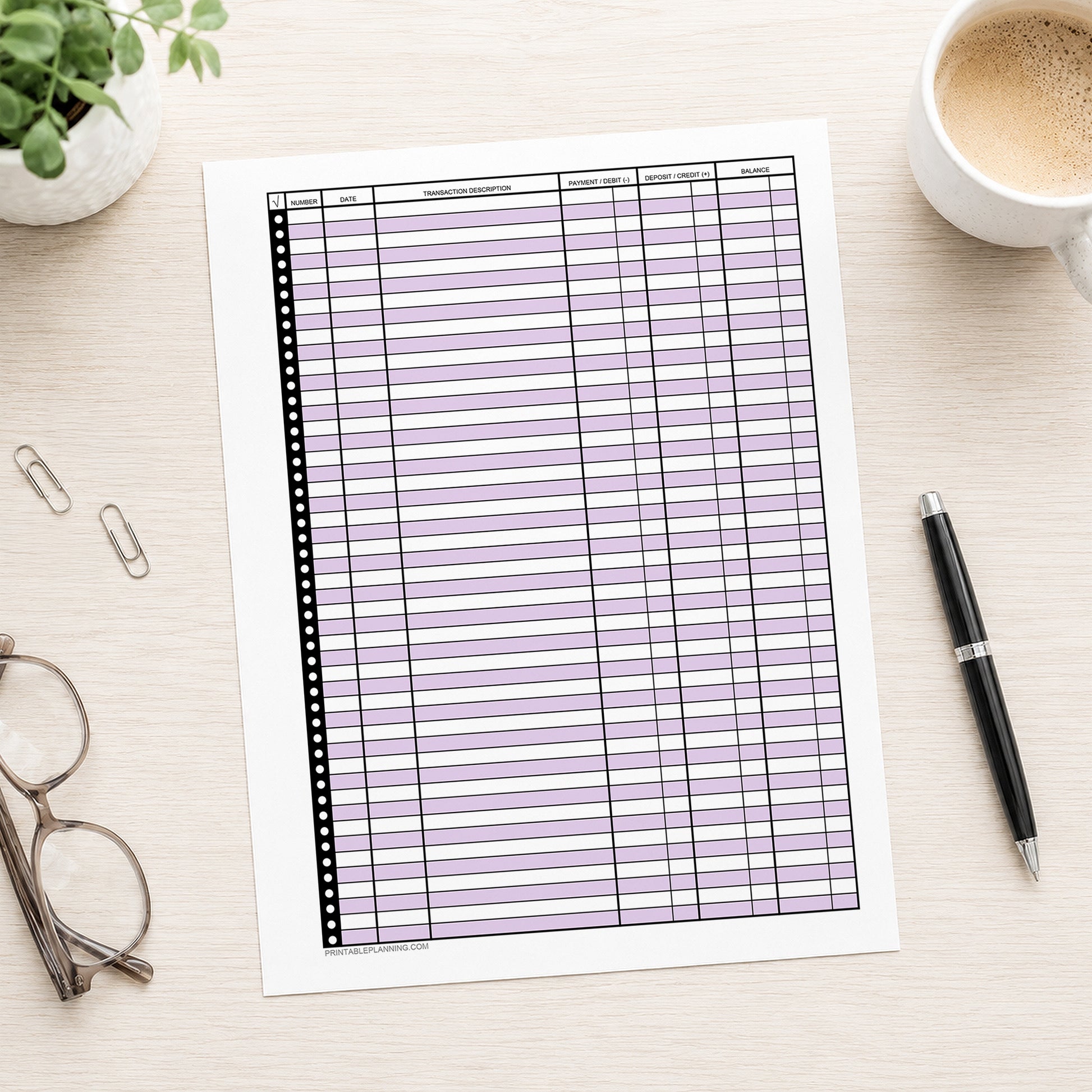 Purple Printable Check Register - Full-Page Transaction Tracker shown on a desk with glasses, a plant, coffee, and a pen.
