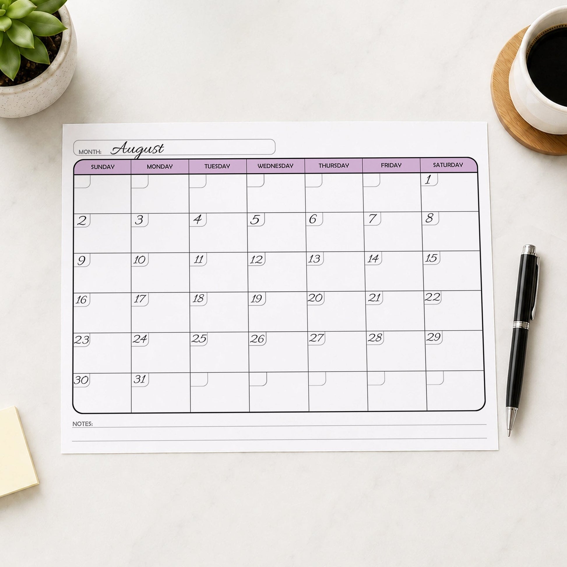 The printed Undated Monthly Calendar - Purple Full-Page Planner (printable) page shown with example writing on a desk with a plant, sticky notes, coffee, and a pen.