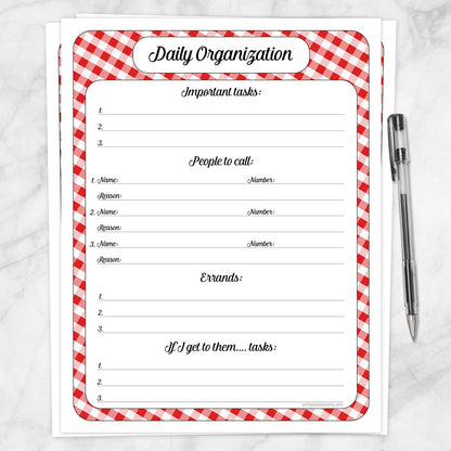 A printable Red Gingham Daily Priority Planner with Calls, Errands & Tasks page shown on a marble surface with a pen.