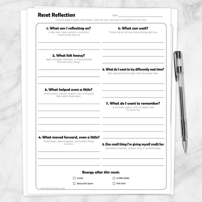 Reset Reflection Printable Worksheet shown on a marble surface with a pen.
