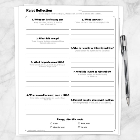 Reset Reflection Printable Worksheet shown on a marble surface with a pen.