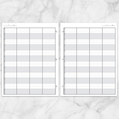 Schedule Sheet in 15 Minute Increments, 4 Columns (printable page), front and back displayed over a marble surface.
