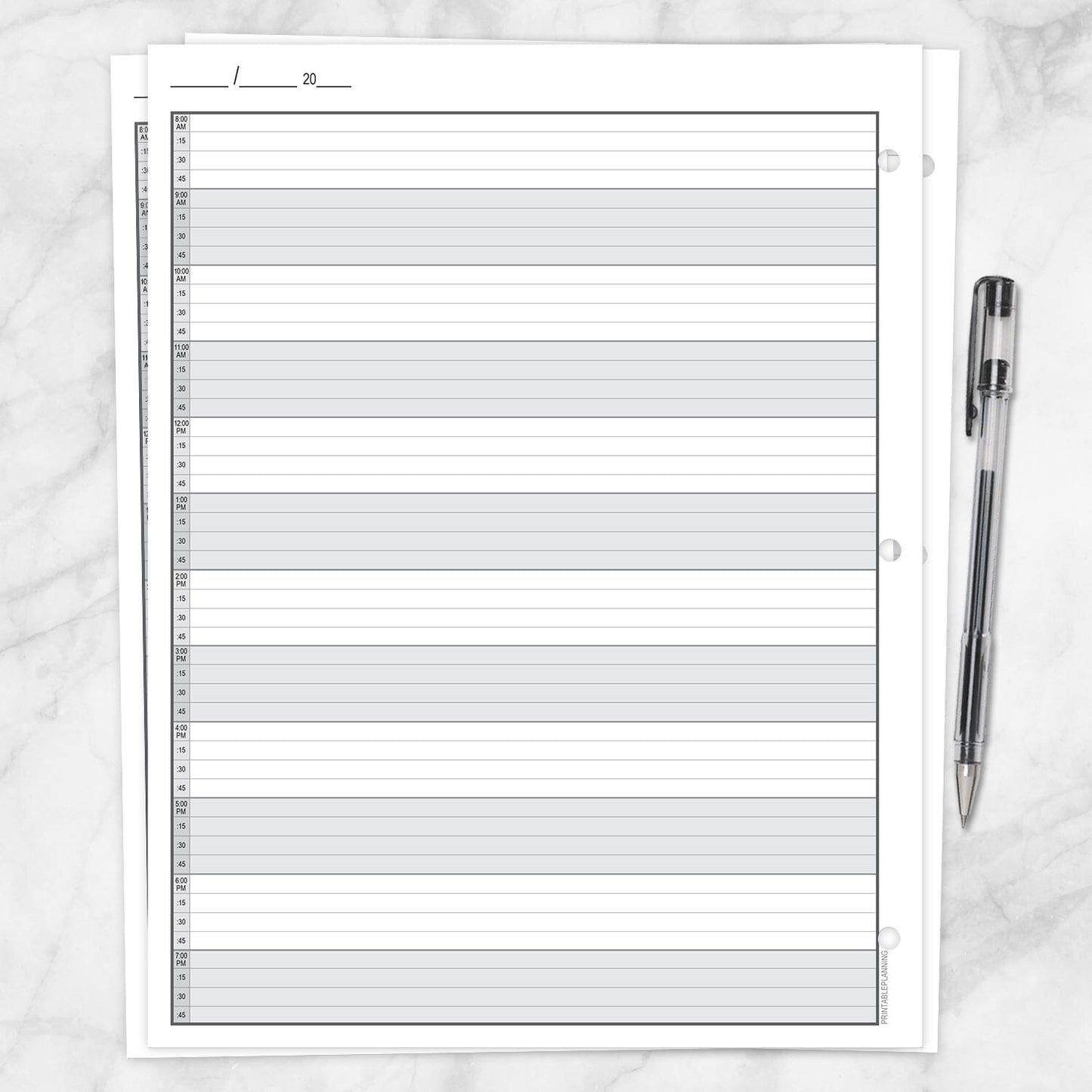 The printable back page of the Full-Width Schedule Sheet in 15-Minute Increments on a marble surface with a pen.