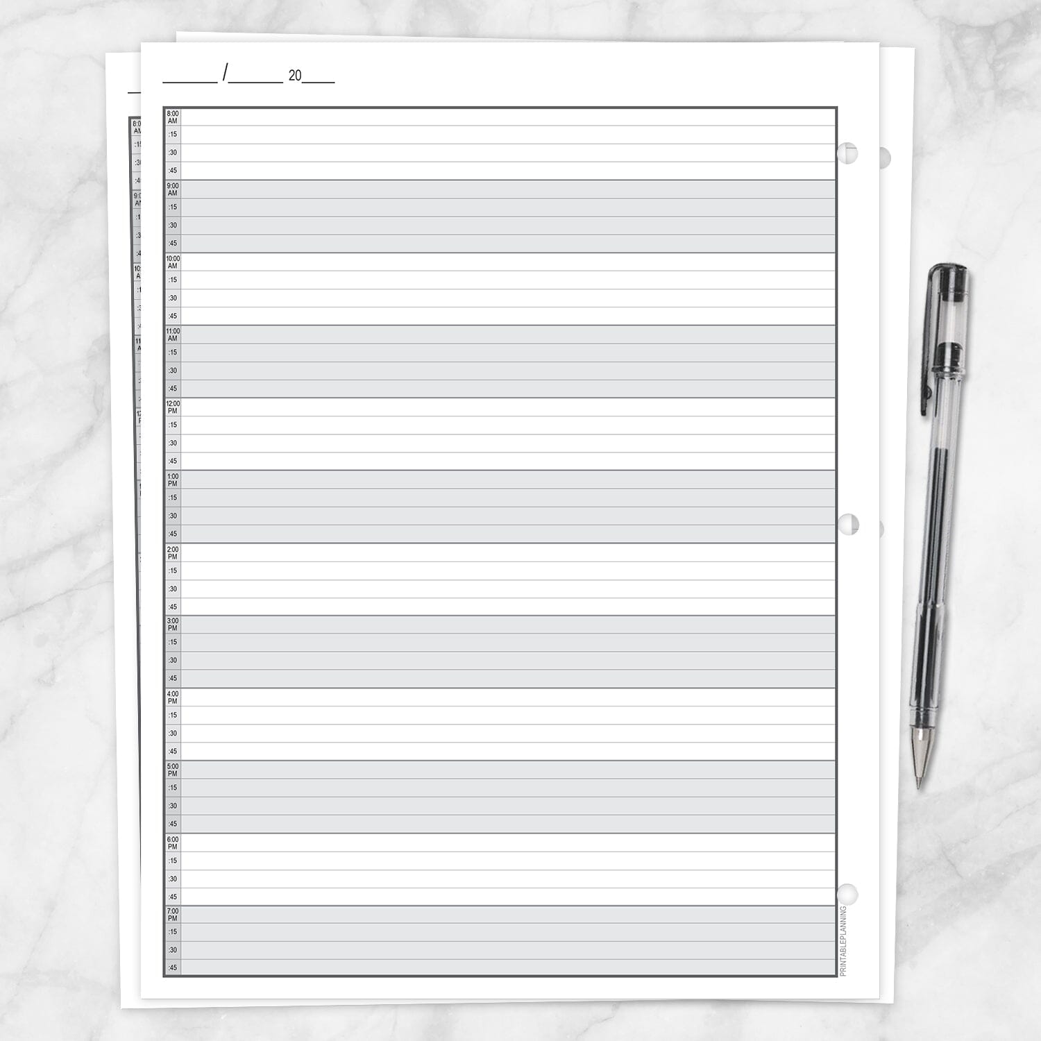 The printable back page of the Full-Width Schedule Sheet in 15-Minute Increments on a marble surface with a pen.